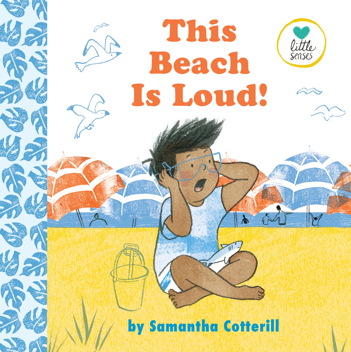 The Beach Is Loud by Samantha Cotterill.  A young boy sits in the sand on the beach with a surprised look on his face, his hands covering his ears. 